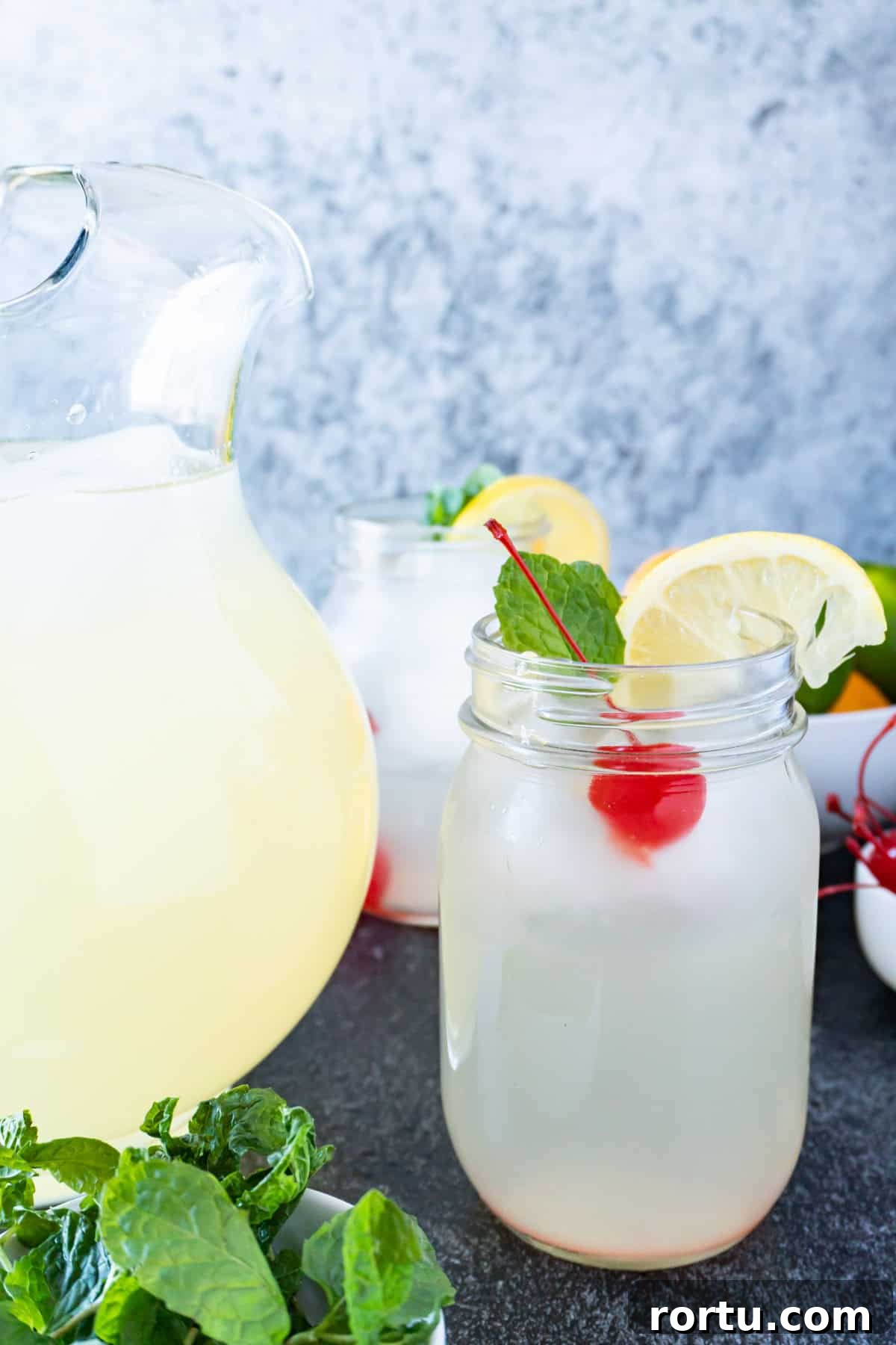non-alcoholic mint julep in glass next to pitcher
