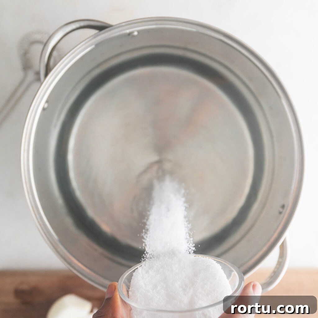 adding salt to a pot of water