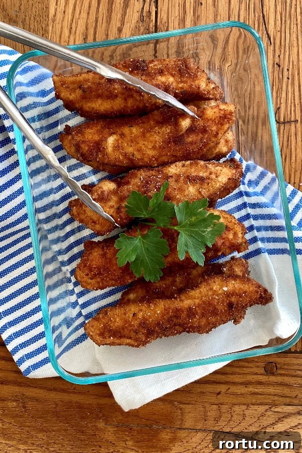 Crispy Buttermilk Fried Chicken Tenders Recipe 2 glass storage dish with chicken fingers.