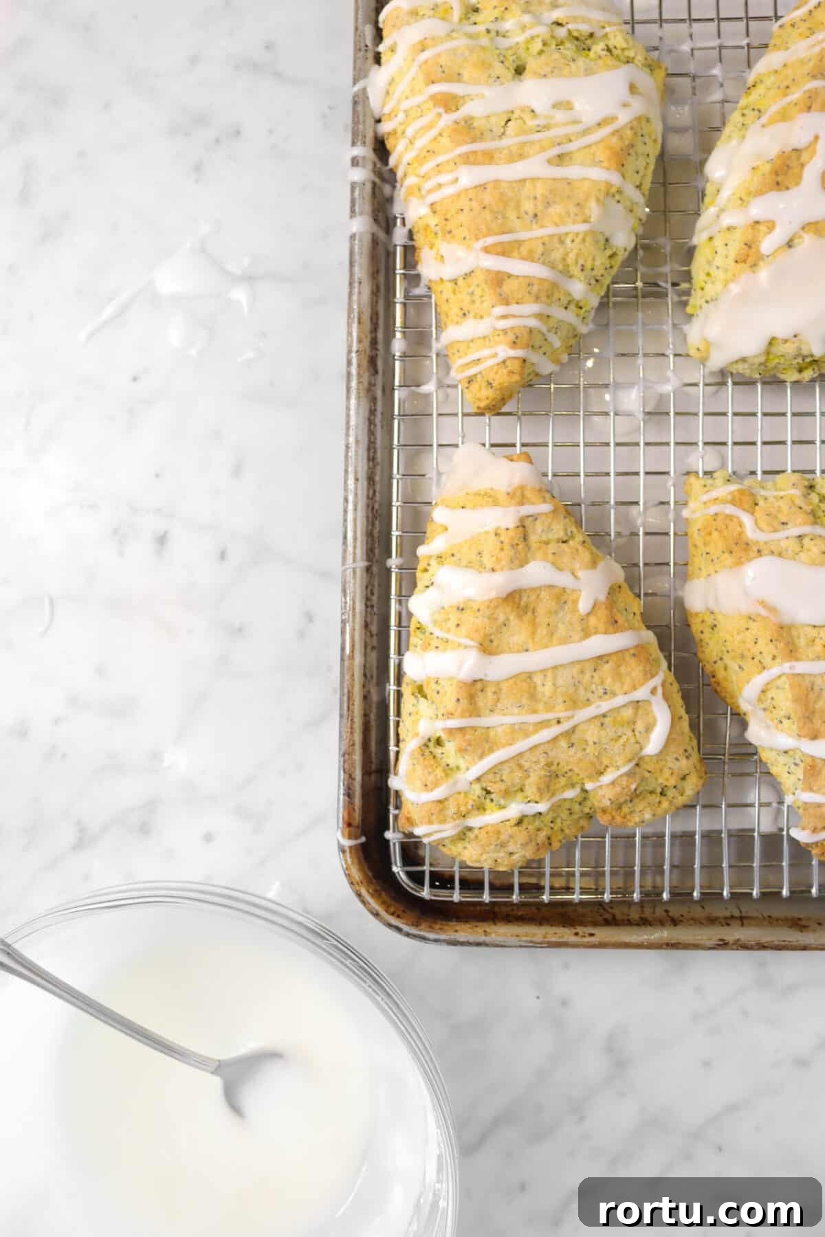 Giant Lemon Poppy Seed Scones — Soft, Zesty Breakfast Treat 8 lemon poppy seed scones with lemon glaze on a sheet pan