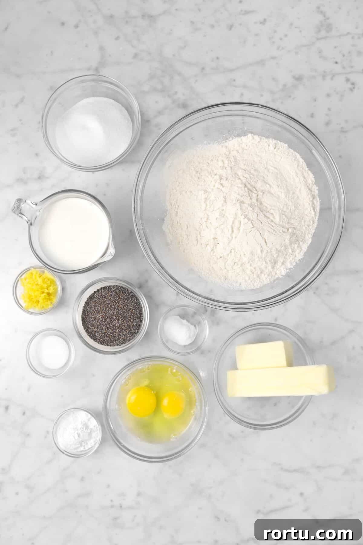 Giant Lemon Poppy Seed Scones — Soft, Zesty Breakfast Treat 4 flour, butter, eggs, baking soda, baking powder, poppyseeds, salt, milk, lemon rind, and sugar in glass bowls
