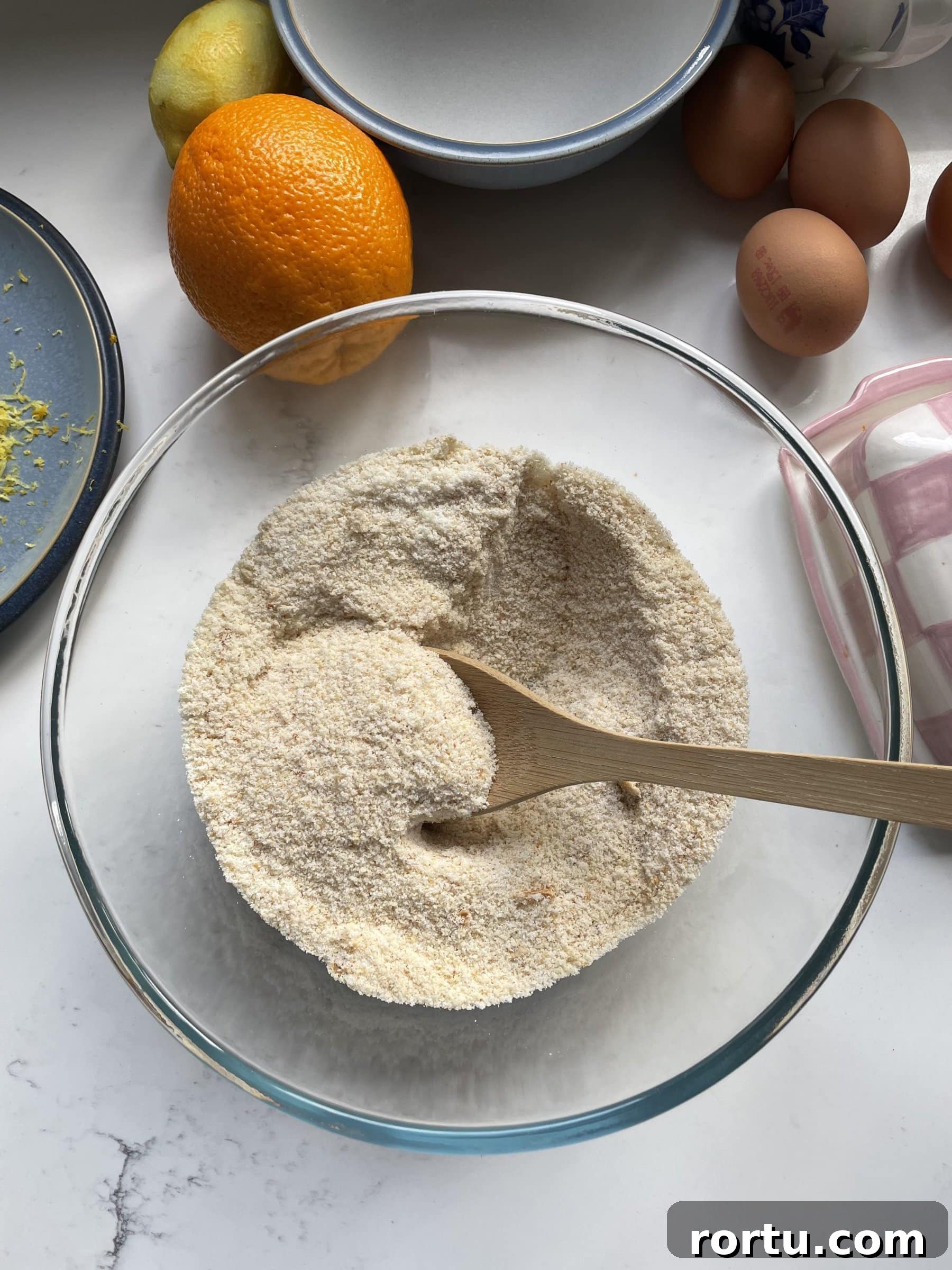 Ballymaloe Tunisian Orange Cake Recipe — Gluten-Free Version 5 Mixing dry ingredients in the glass mixing bowl.