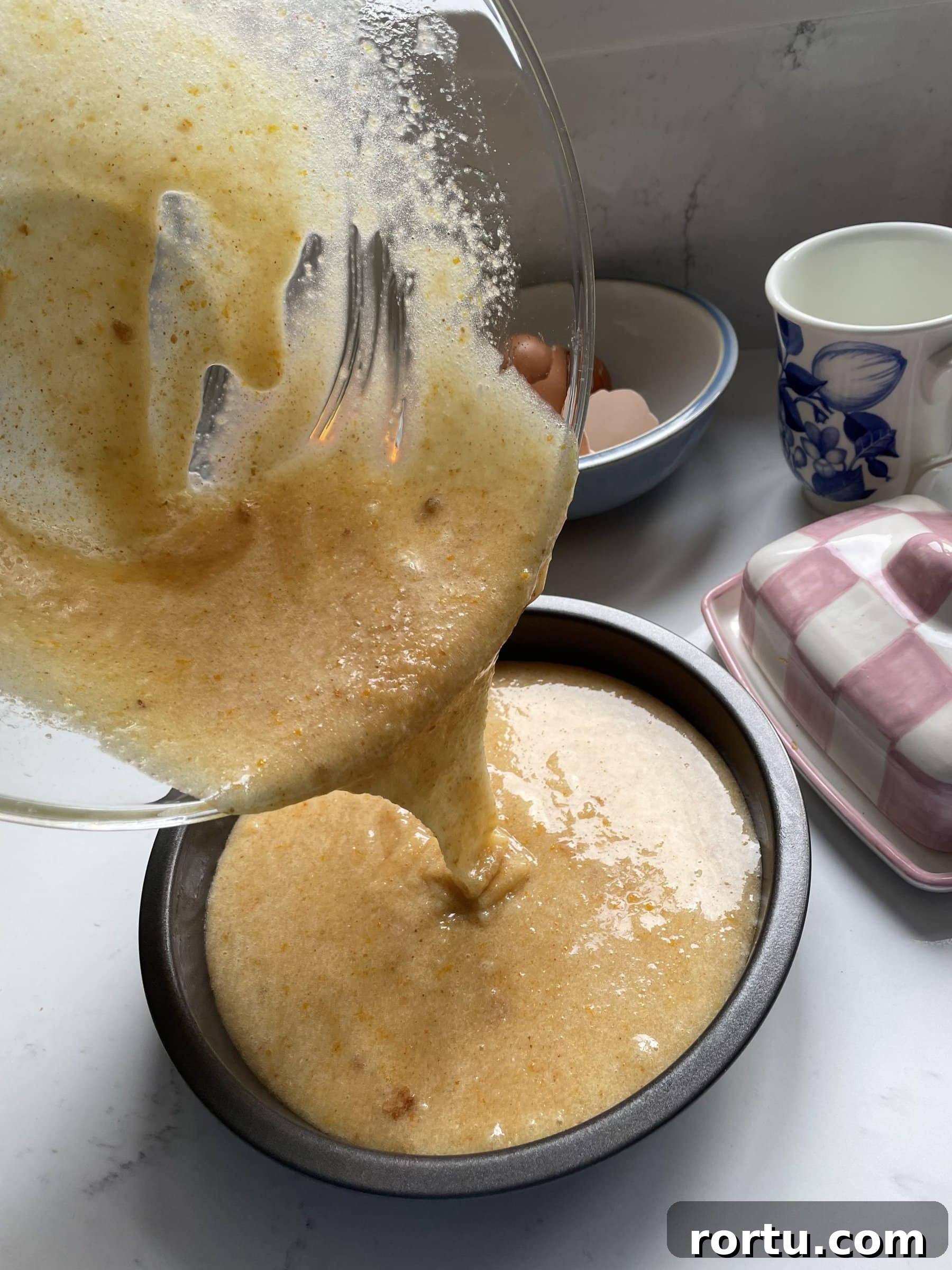 Ballymaloe Tunisian Orange Cake Recipe — Gluten-Free Version 8 Pouring Tunisian orange cake mix into lined cake tin.