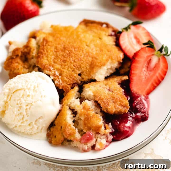 Top down view of strawberry cobbler on a plate.