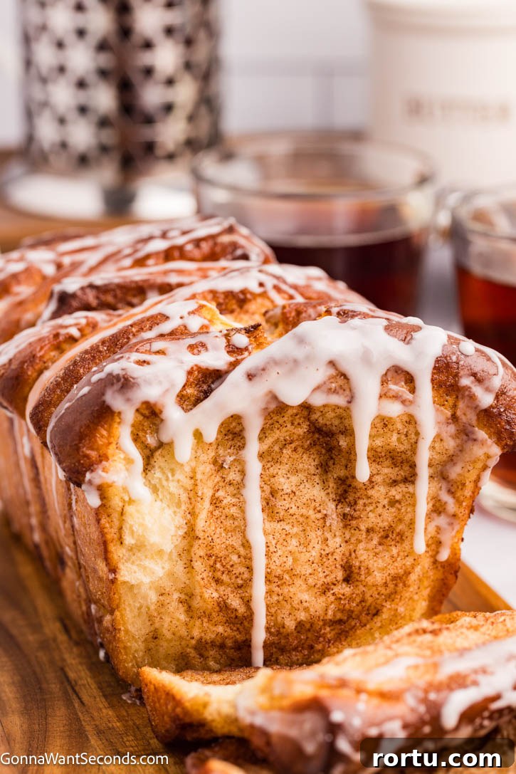 cinnamon pull apart bread with sweet powdered sugar glaze dripping