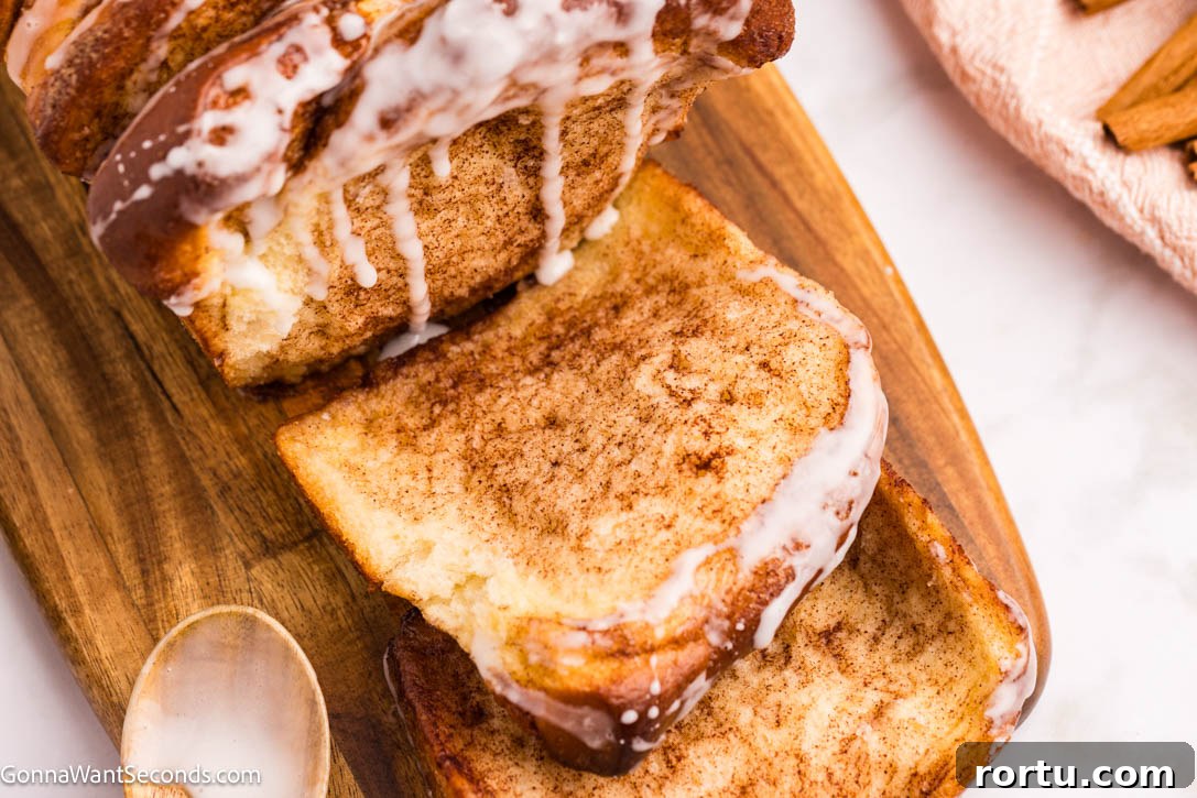 cinnamon pull apart bread with sweet powdered sugar glaze dripping