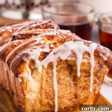 cinnamon pull apart bread with sweet powdered sugar glaze dripping