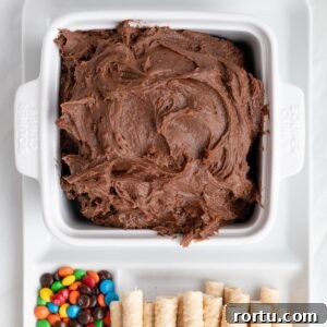 brownie dip with add-ins and dippers on a platter