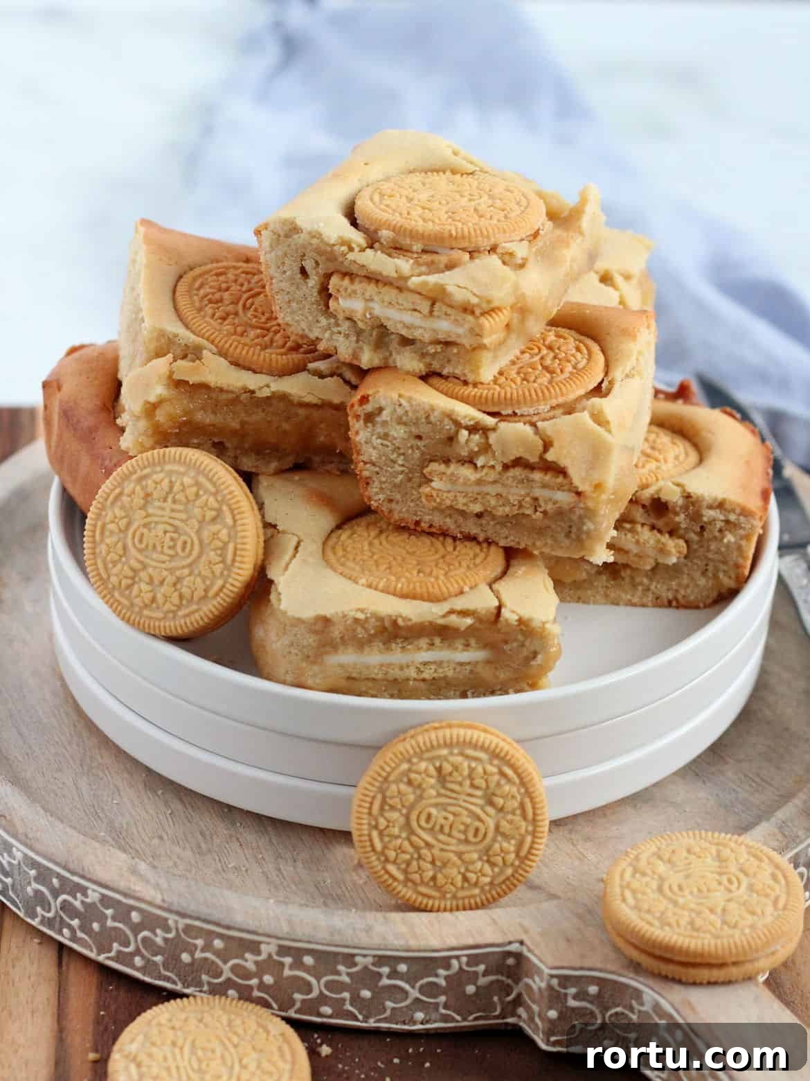 Pile of Oreo blondies on white plates