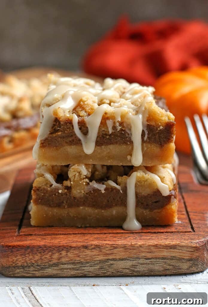 Paleo Vegan Pumpkin Crumble Bars for Fall Baking 6 stack of paleo pumpkin crumb bars with glaze dripping down the side