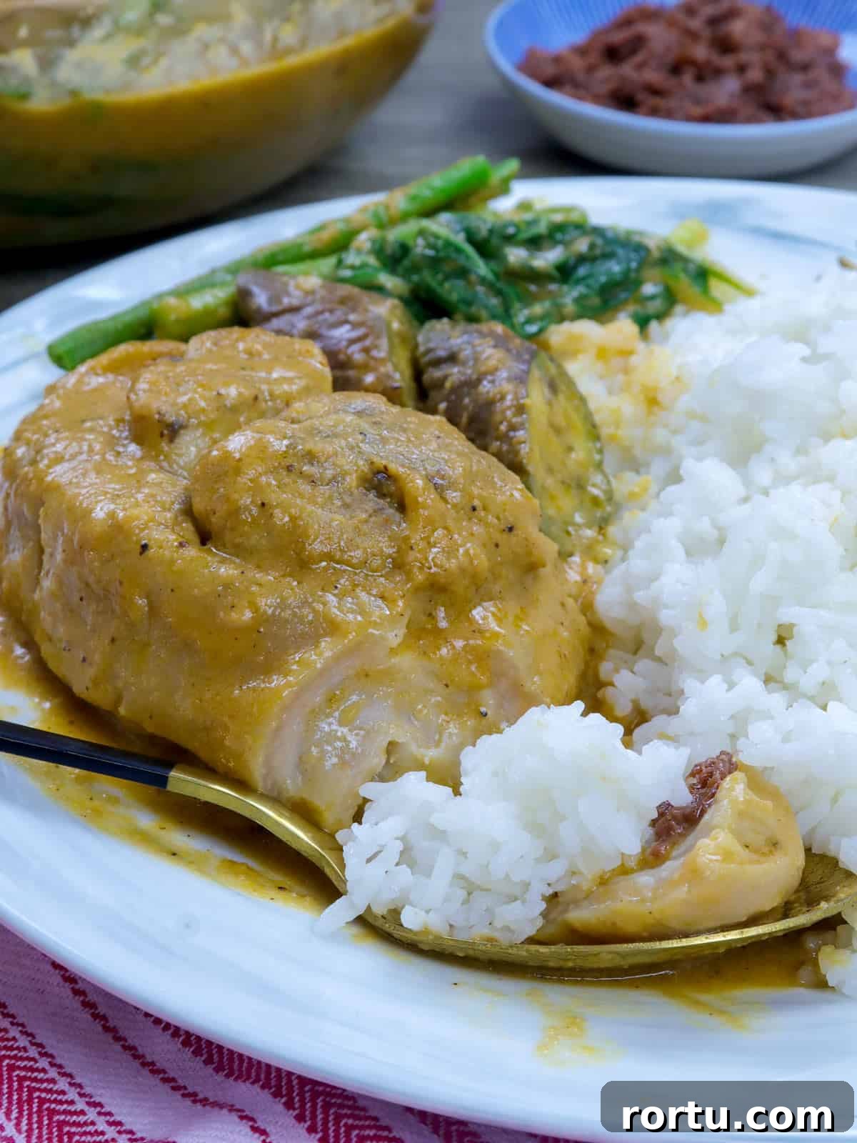 Braised Pork Hocks (Kare-Kareng Pata) Recipe 5 eating pork kare kare on a white plate with steamed rice