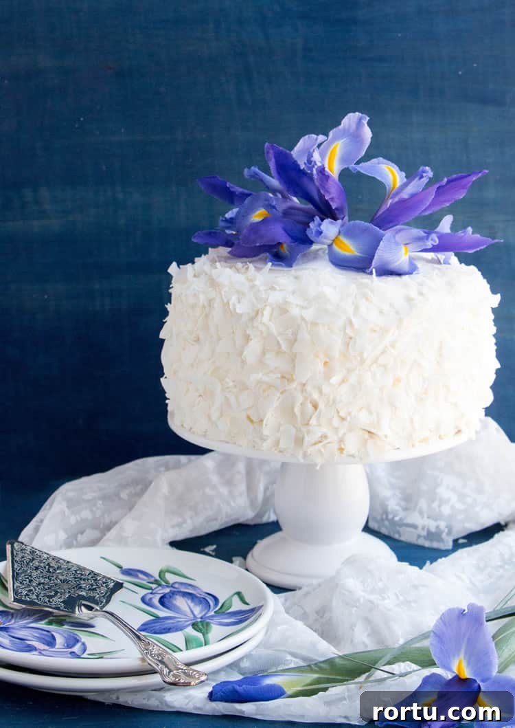 Mandarin Orange Pineapple Cream Cake. Layers of mandarin orange cake, filled with pineapple coconut pastry cream and covered in pineapple whipped cream and coconut chips. Perfect for Easter or Spring gatherings.