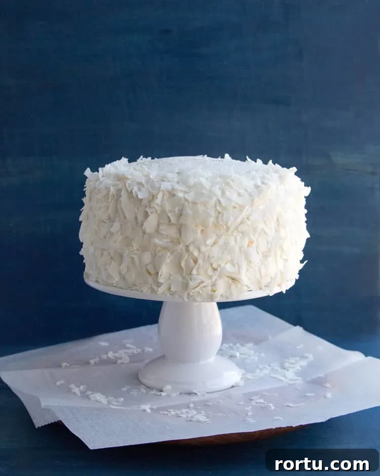 Mandarin Orange Pineapple Cream Cake. Layers of mandarin orange cake, filled with pineapple coconut pastry cream and covered in pineapple whipped cream and coconut chips. Perfect for Easter or Spring gatherings.