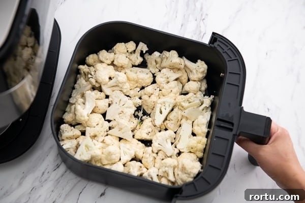 Cauliflower in an air fryer basket