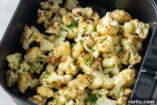Cooked cauliflower in an air fryer basket