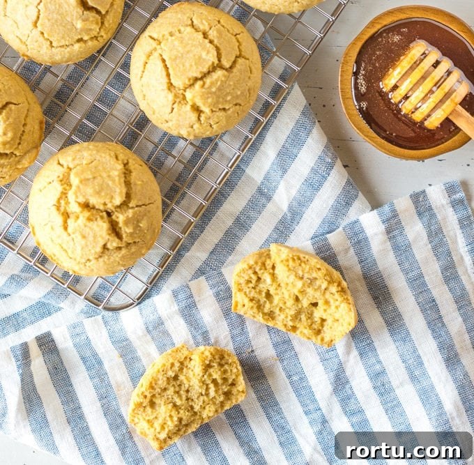 muffins on a towel and wire rack with honey aside