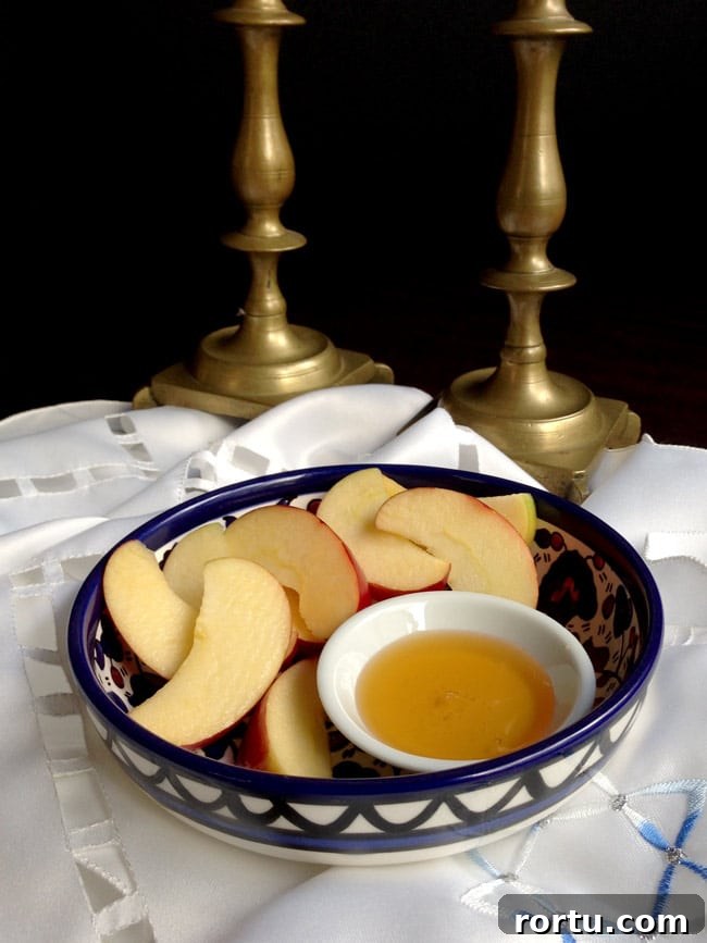 Olive Oil Pear Cake with Ginger and Cinnamon 4 Apples and honey in a bowl with candlesticks in background