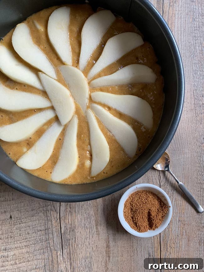 Olive Oil Pear Cake with Ginger and Cinnamon 7 Pear cake batter in round pan with cinnamon sugar, ready to go into the oven.