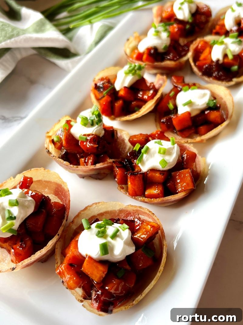 Bacon cups assembled with sweet potatoes, sour cream, and chives