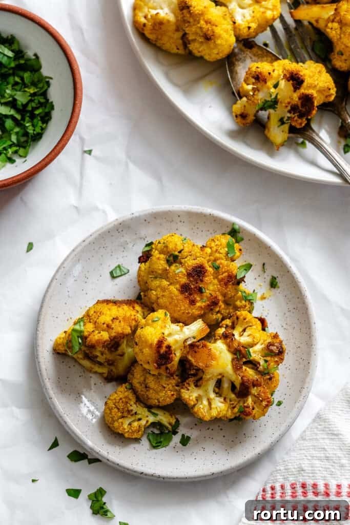 Curry-Roasted Cauliflower Recipe: Crispy Spiced Cauliflower Roast 3 Curry Roasted Cauliflower on small white plate