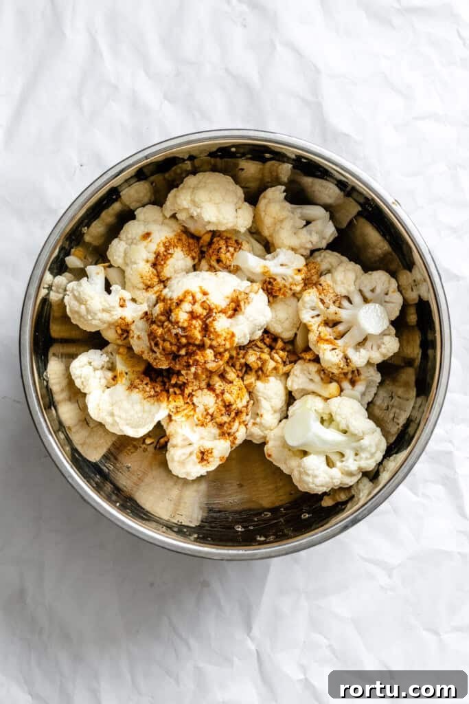 Curry-Roasted Cauliflower Recipe: Crispy Spiced Cauliflower Roast 8 Curry Roasted Cauliflower in a bowl with spices