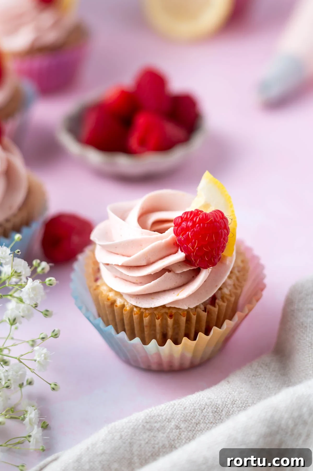 Lemon Raspberry Cupcakes Made from Scratch: Bright Summer Recipe 10 lemon raspberry cupcake with a buttercream swirl and lemon slice and raspberry on top