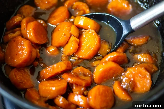 Southern Candied Yams Recipe with Video — Classic Southern Side Dish 5 Candied yams in a pot cooked on the stovetop