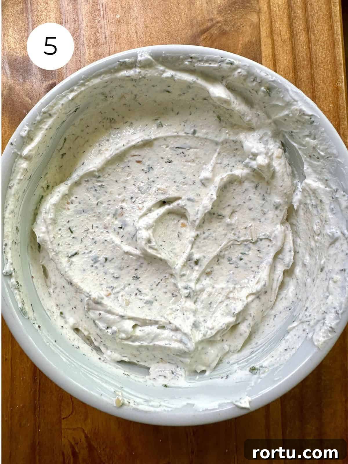 Blended herb and garlic dip in a bowl.