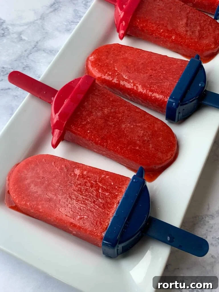 Simple strawberry popsicles on white tray