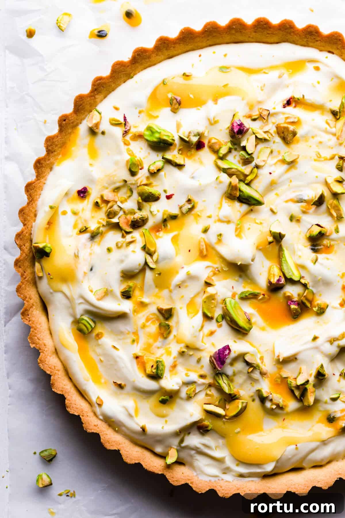 Lemon Mascarpone Tart Recipe — Creamy Citrus Dessert 2 top view super close up at a sweet tart with lemon curd, mascarpone and pistachios