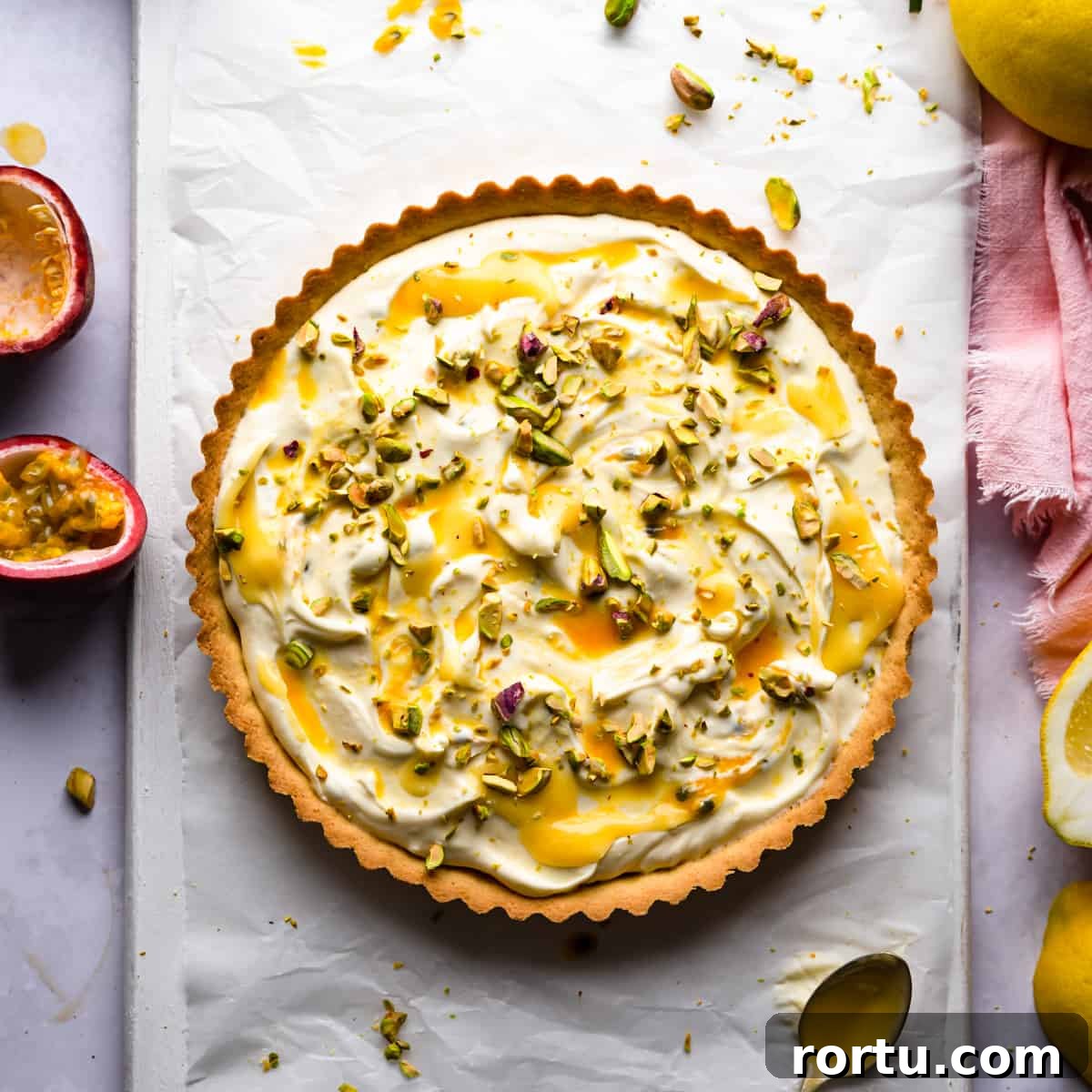 Lemon Mascarpone Tart Recipe — Creamy Citrus Dessert 7 lemon mascarpone tart topped with lemon curd and chopped pistachios.