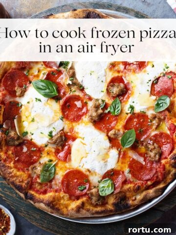 A cooked pizza topped with fresh basil, pepperoni slices and cheese with the title "how to cook frozen pizza in an air fryer" over it.