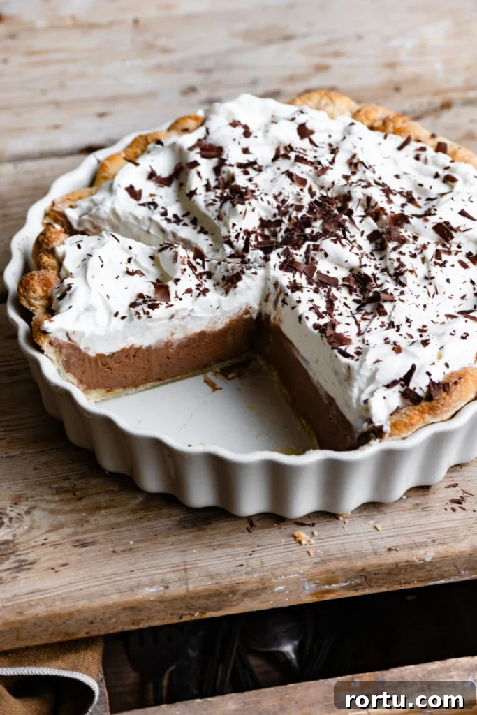 Overhead view of a French Silk Pie in a pie dish on a wood table.