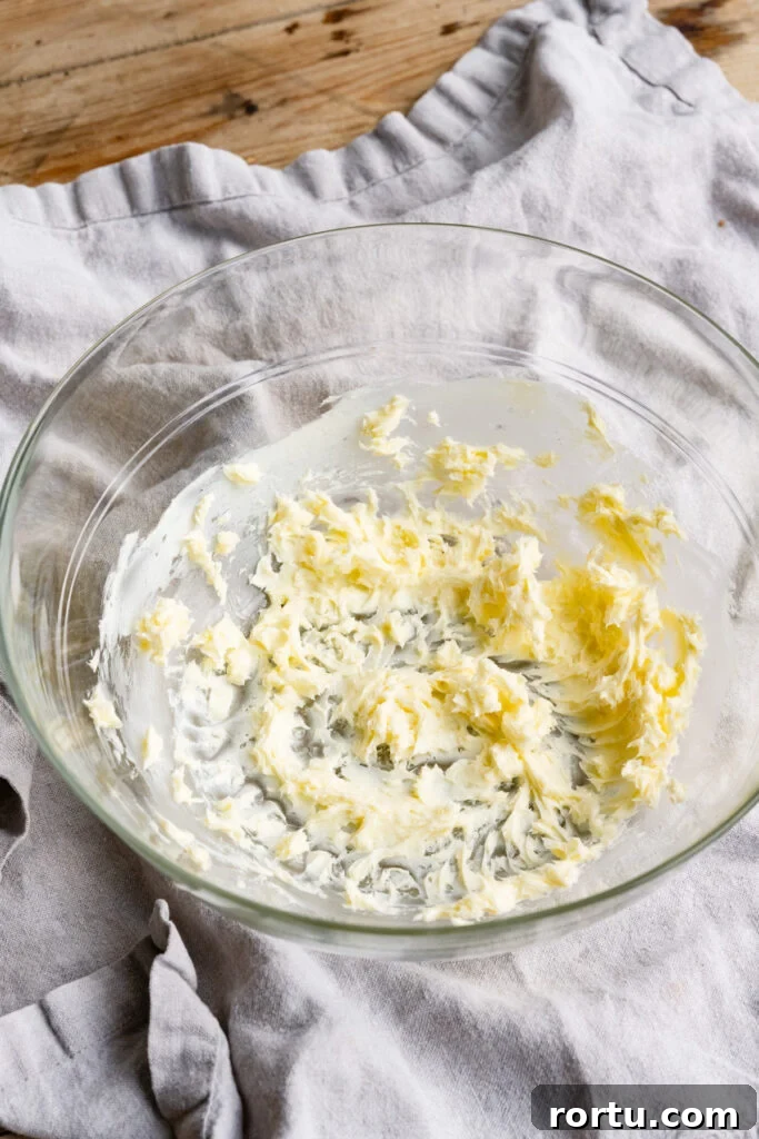 Softened butter beaten smoothly in a large glass bowl.