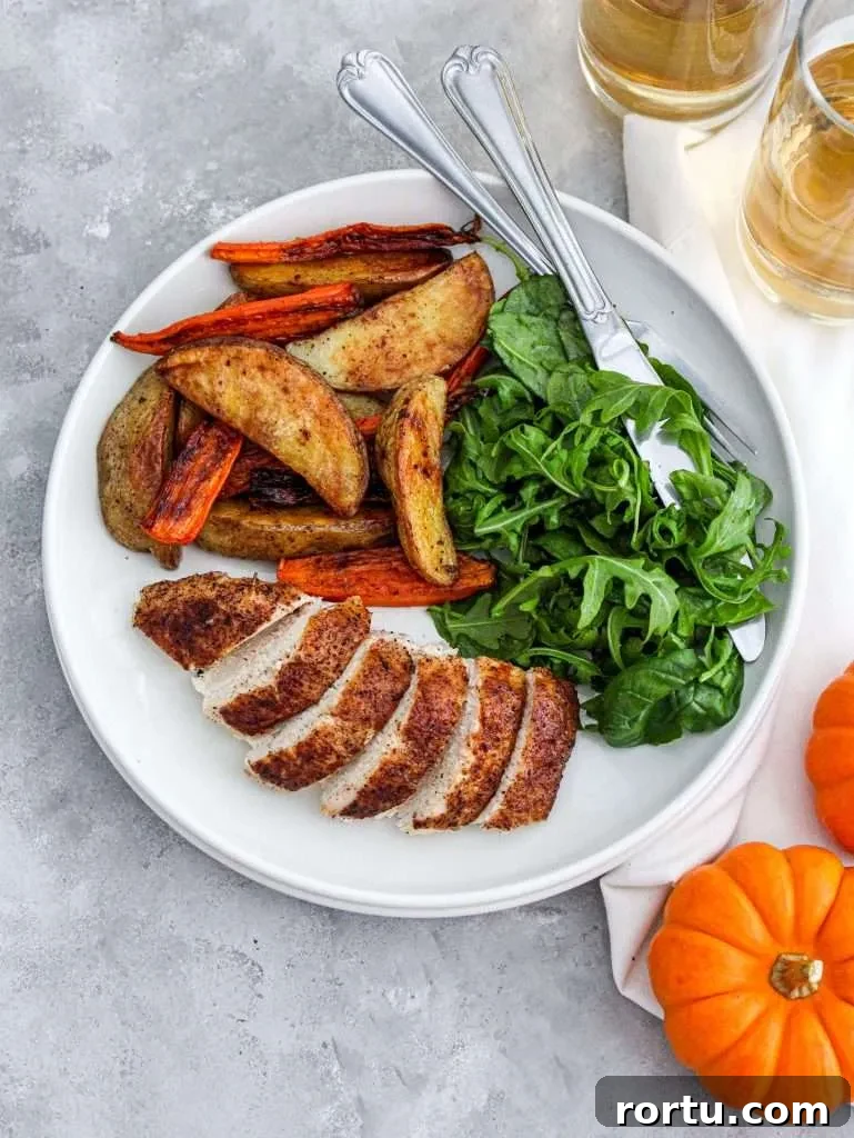 fall spice roasted chicken plated with green salad overhead image