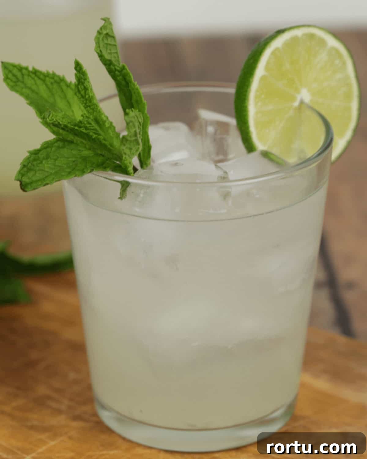 A glass of moonshine mojito garnished with fresh mint and a lime wedge.