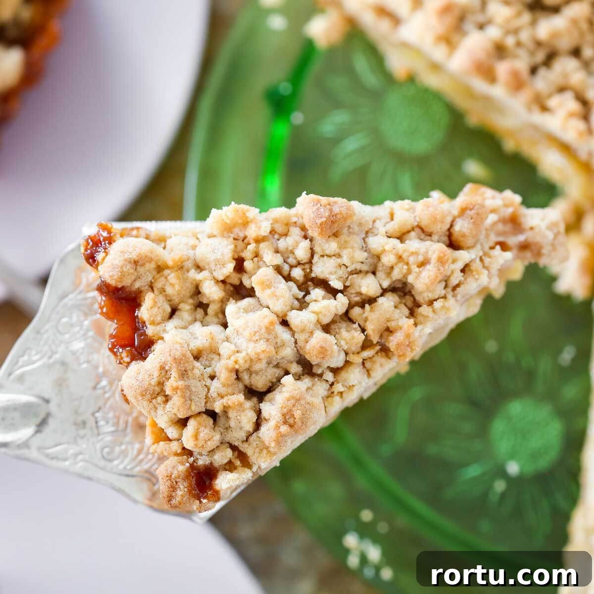 Perfect Streusel Topping Recipe for Crispy, Buttery Crumbles 3 streusel on top of apple tart slice.