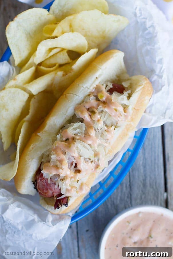 Pastrami Wrapped Hot Dog with potato chips in a basket.