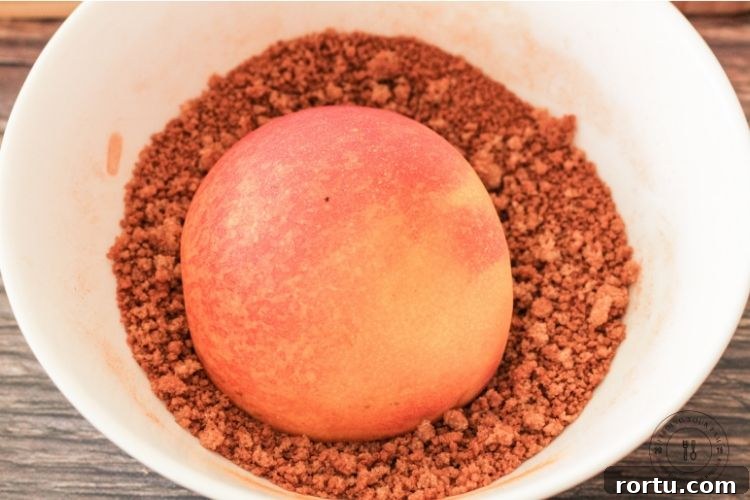 slice peach cut side down in a bowl of brown sugar and cinnamon