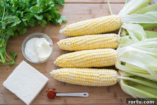 Cobs on Corn on Cutting Board with Cheese and Cilantro