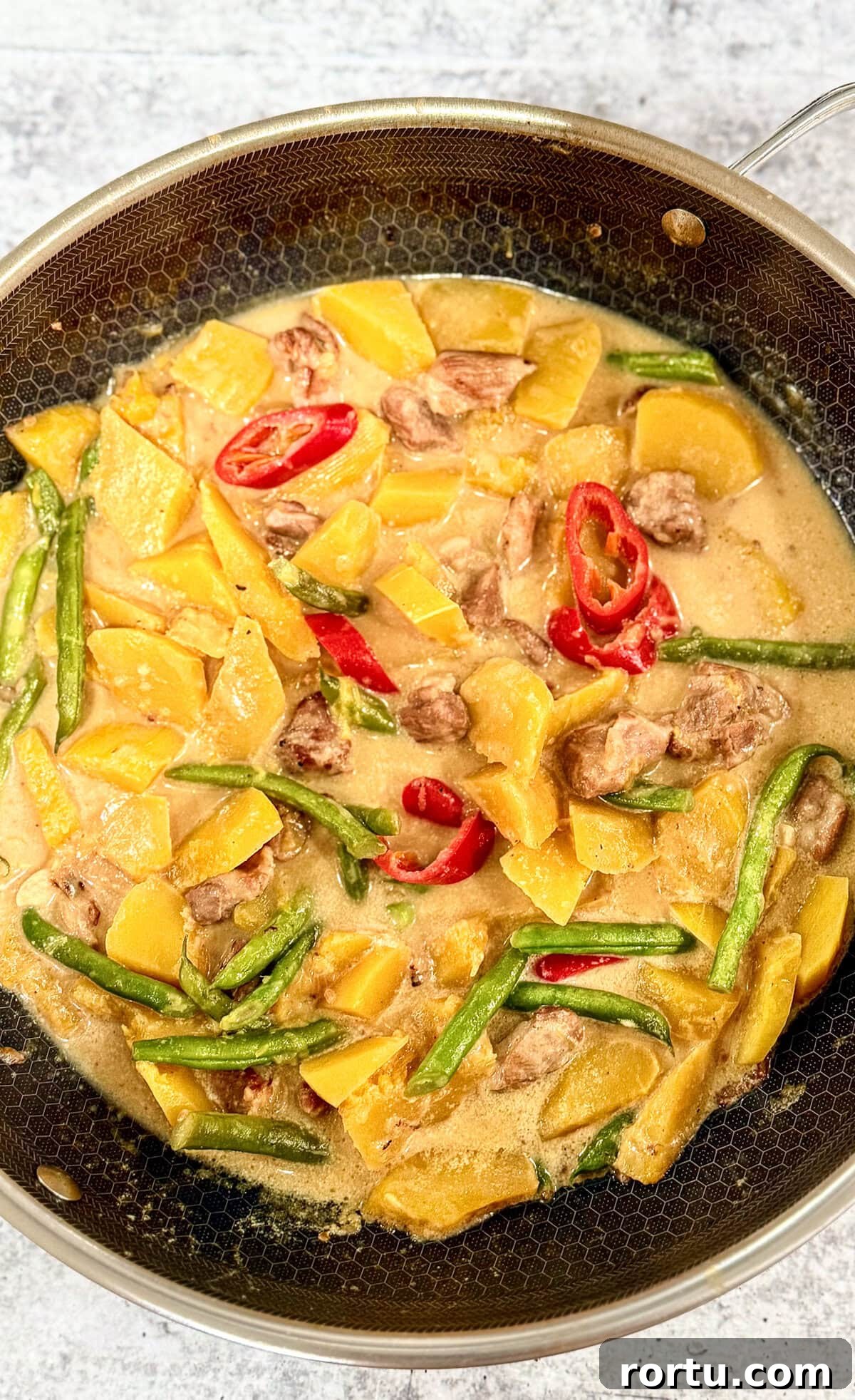 A classic Filipino vegetable and meat dish, this sauteed butternut squash with pork (Ginisang Kalabasa) is so yummy and easy to make. Paired with rice, it's such a tasty and wholesome meal! You will find this dish in any cafeteria all over the country. #ginisangkalabasa #butternutrecipes #butternutsquashwithpork | manilaspoon.com Sauteed Butternut Squash with Pork (Ginisang or Ginataang Kalabasa)
