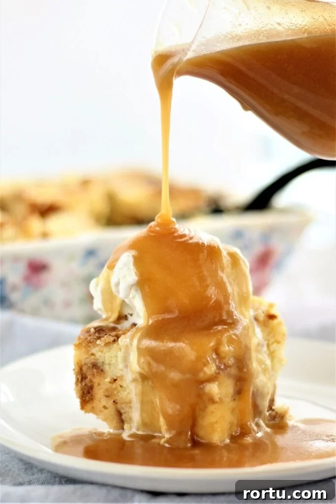 Gluten-Free ʻOhana Bread Pudding Recipe – Hawaiian Comfort Dessert 2 pouring butter rum sauce over bread pudding on white plate
