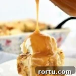 Gluten-Free ʻOhana Bread Pudding Recipe – Hawaiian Comfort Dessert 11 pouring butter rum sauce over bread pudding on white plate