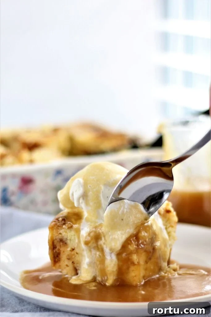 Gluten-Free ʻOhana Bread Pudding Recipe – Hawaiian Comfort Dessert 4 scooping a spoonful of bread pudding with vanilla ice cream