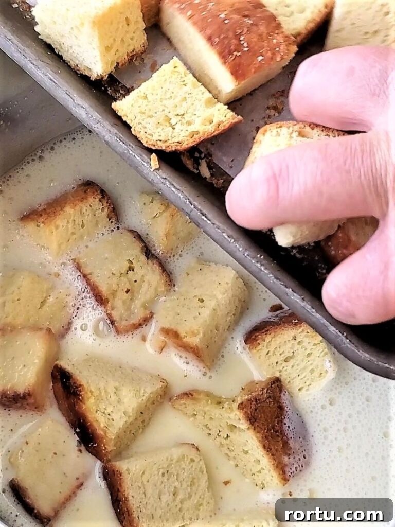 Gluten-Free ʻOhana Bread Pudding Recipe – Hawaiian Comfort Dessert 7 adding bread cubes into custard