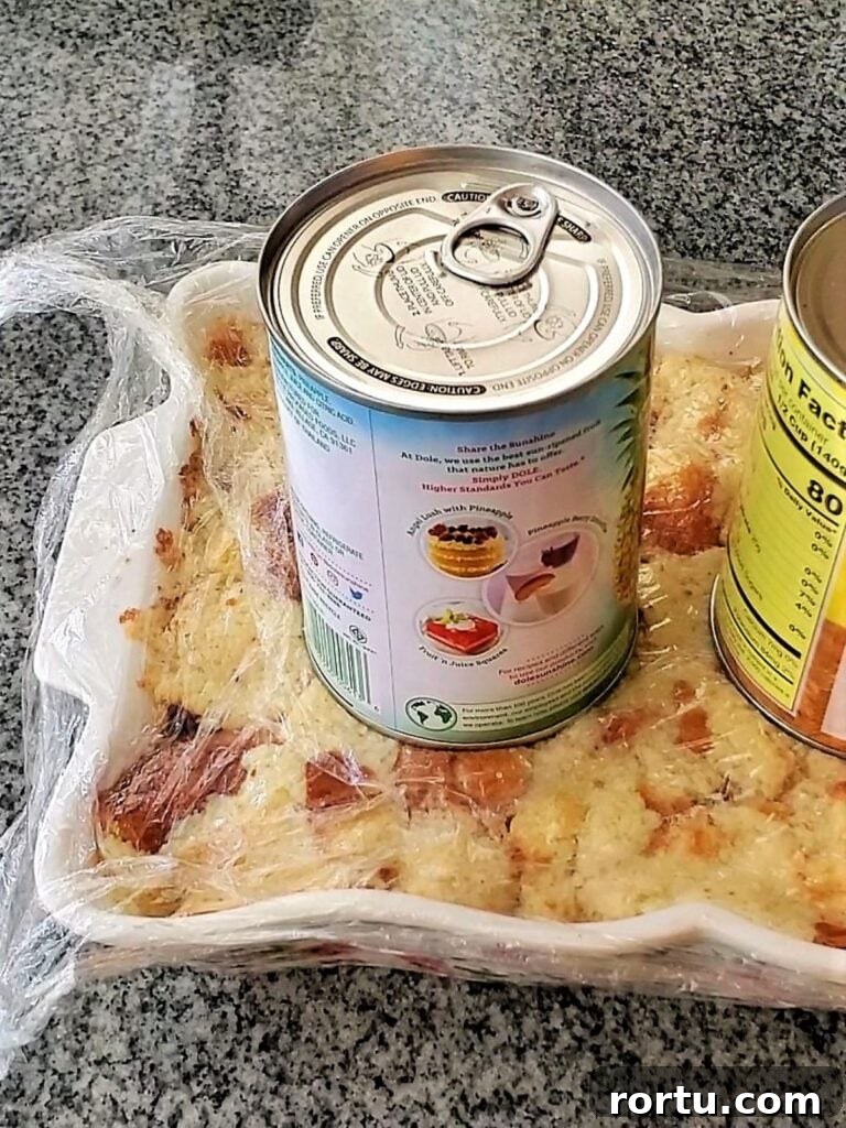 Gluten-Free ʻOhana Bread Pudding Recipe – Hawaiian Comfort Dessert 8 pressing heavy cans on top of bread pudding