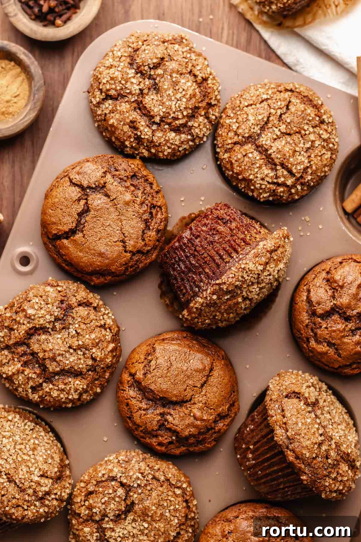 Baked gingerbread muffins in a muffin tin.
