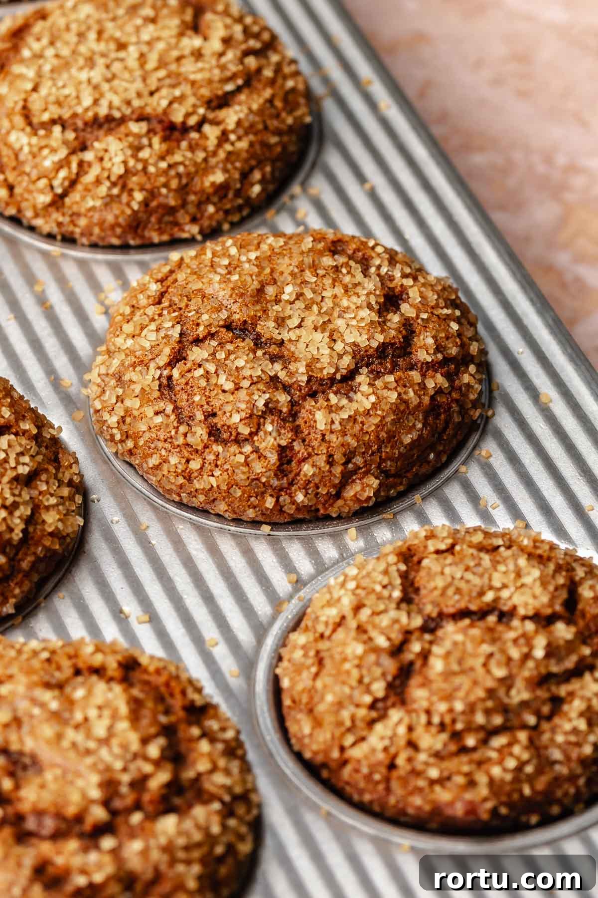 Baked gingerbread muffins in a muffin tin.