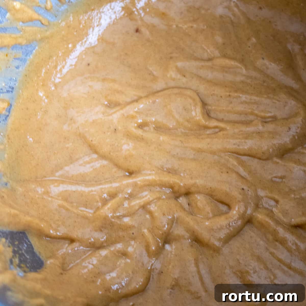 Added dry ingredients to the mixing bowl to make a pumpkin batter.