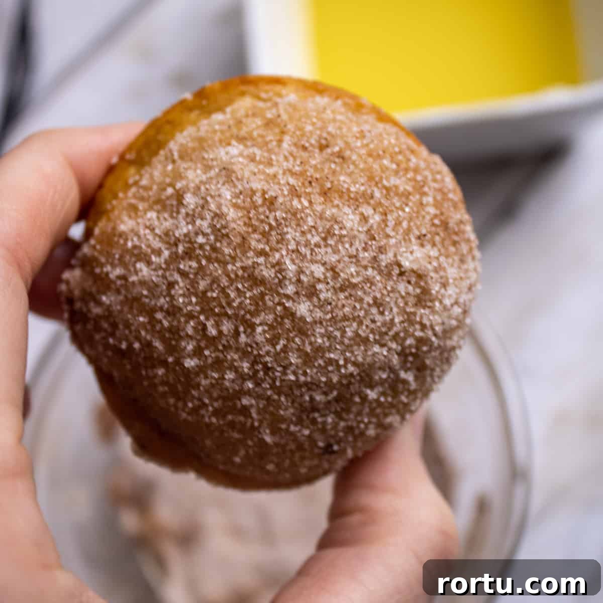 A pumpkin donut muffin dipped in cinnamon sugar. 